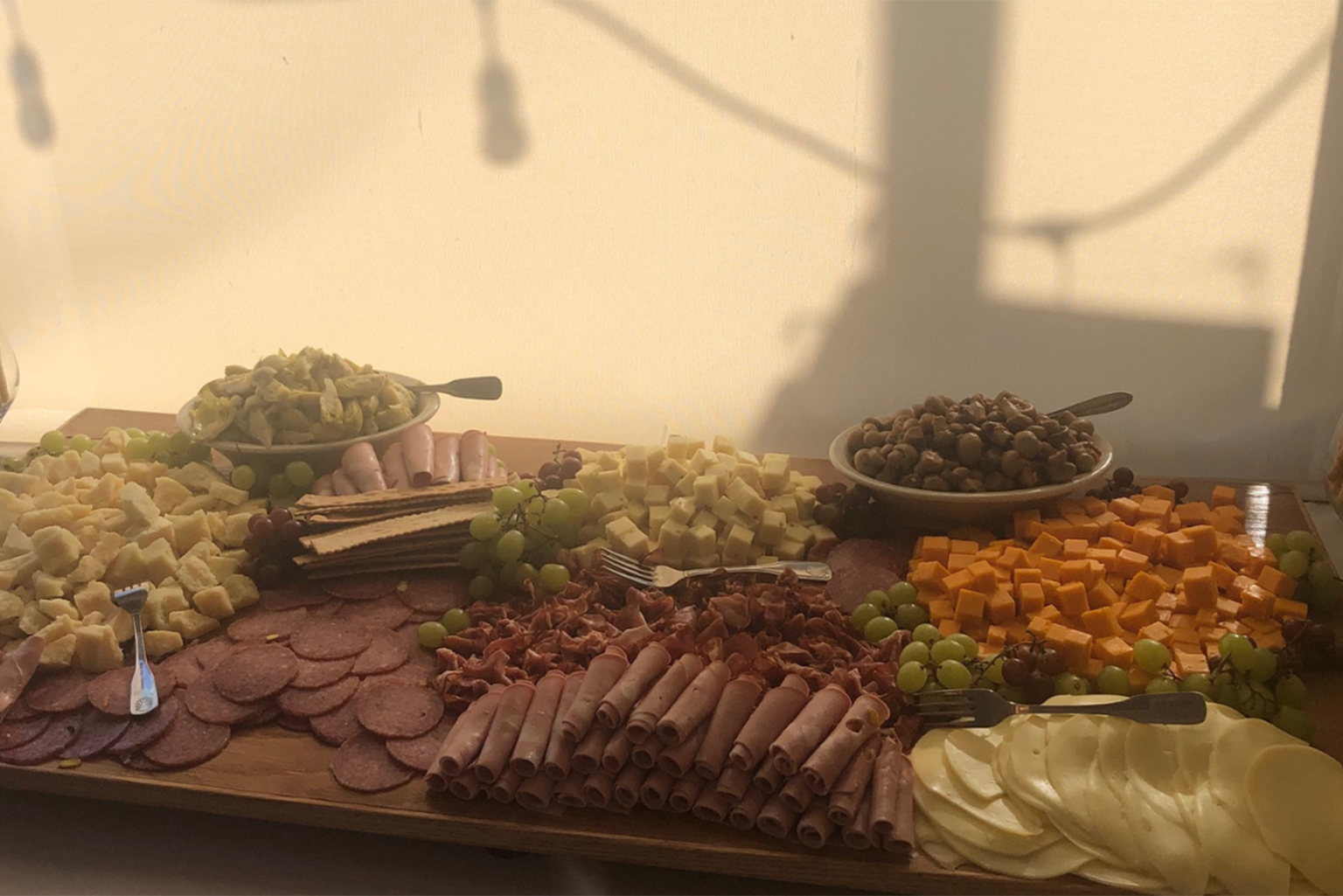 a wooden table topped with lots of different types of food.