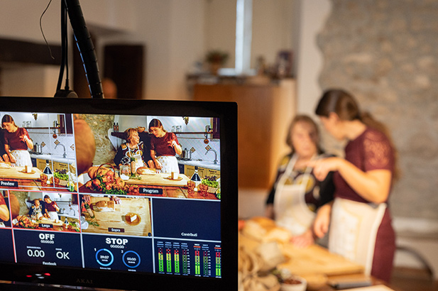 a television with a picture of people cooking on it.